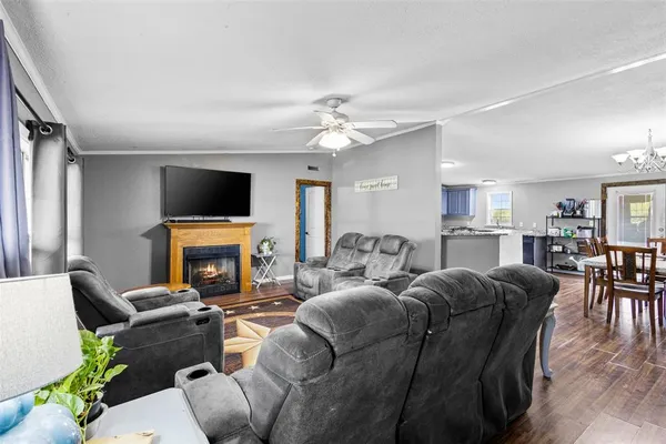 a living room with furniture a fireplace and a flat screen tv
