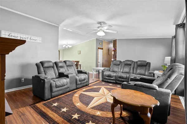 a living room with furniture and a chandelier