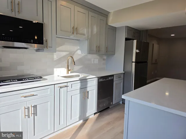 a kitchen with a sink a stove and refrigerator