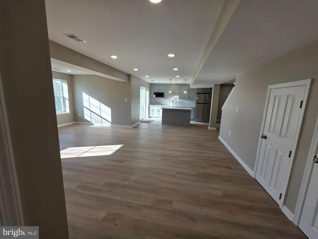 a view of a kitchen with wooden floor