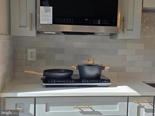 a stove top oven sitting inside of a kitchen