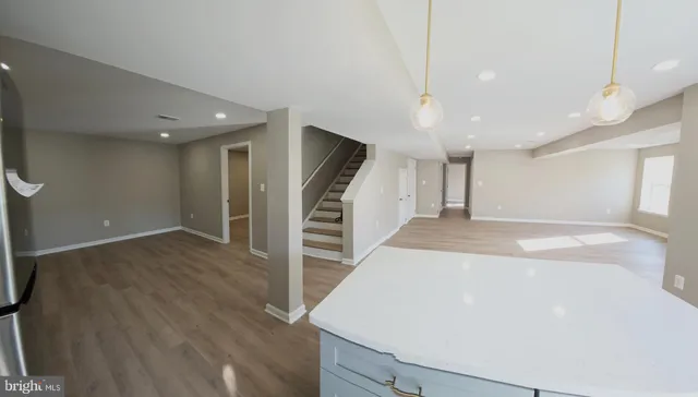 a view of a kitchen with a sink and a refrigerator