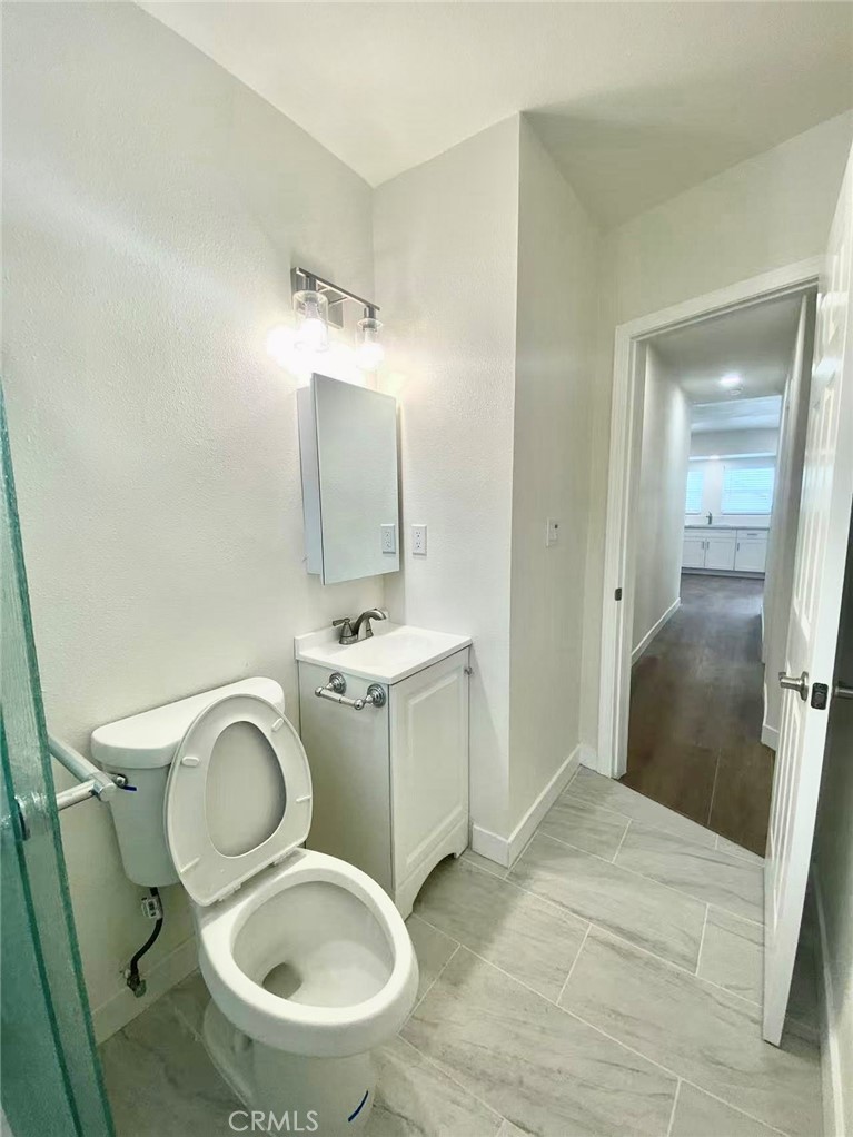 920 West Olive Avenue, Unit 1 Monrovia, CA 91016 - Photo 12 of 13 a bathroom with a toilet sink and mirror