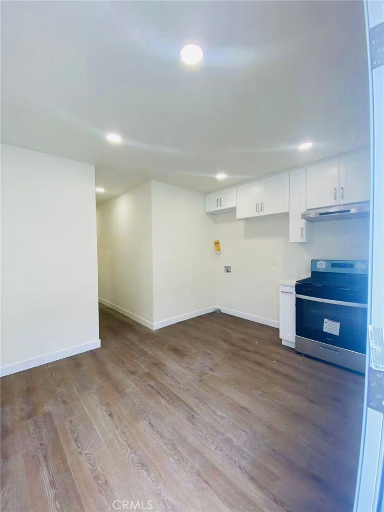 920 West Olive Avenue, Unit 1 Monrovia, CA 91016 - Photo 5 of 13 a view of kitchen and empty room with wooden floor