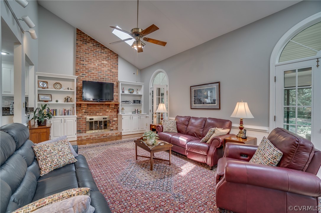 13131 Drakewood Road Midlothian, VA 23113 - Photo 16 of 29 a living room with furniture a fireplace and a flat screen tv