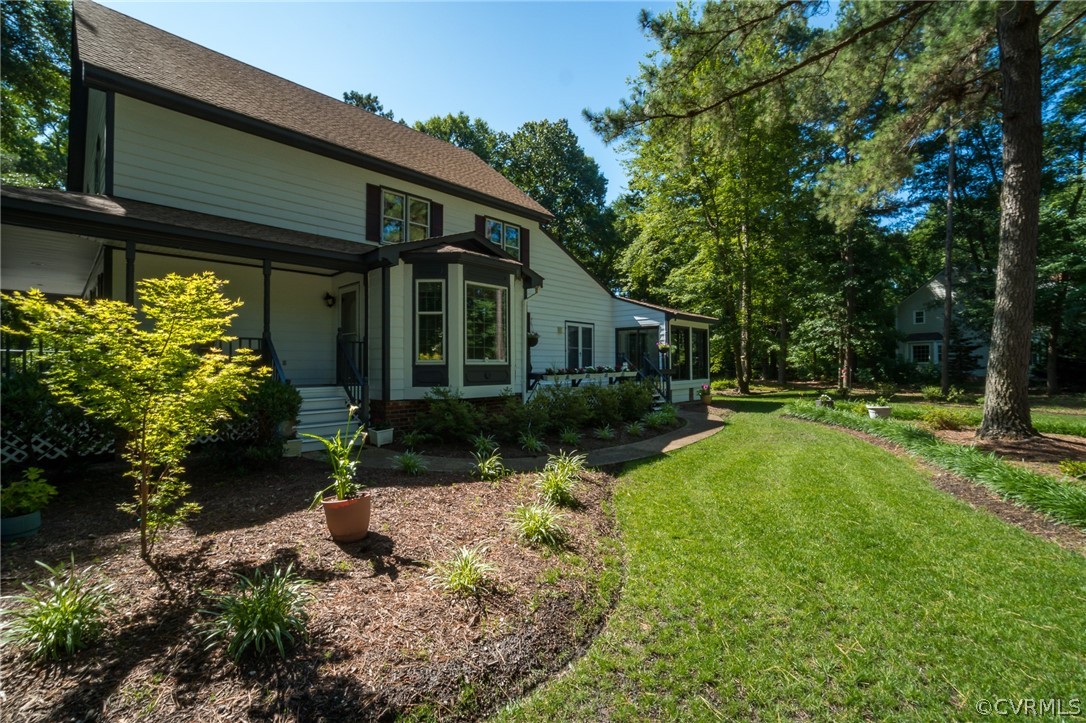 13131 Drakewood Road Midlothian, VA 23113 - Photo 2 of 29 a front view of a house with garden