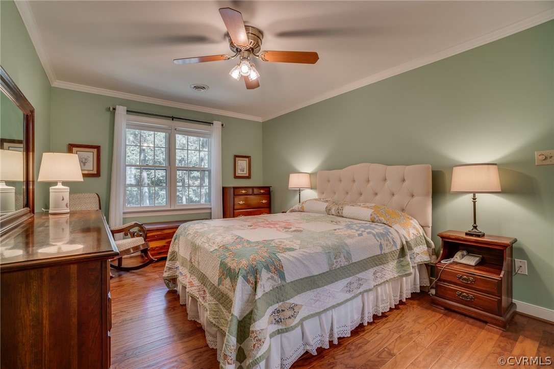 13131 Drakewood Road Midlothian, VA 23113 - Photo 25 of 29 a bedroom with a bed and wooden floor