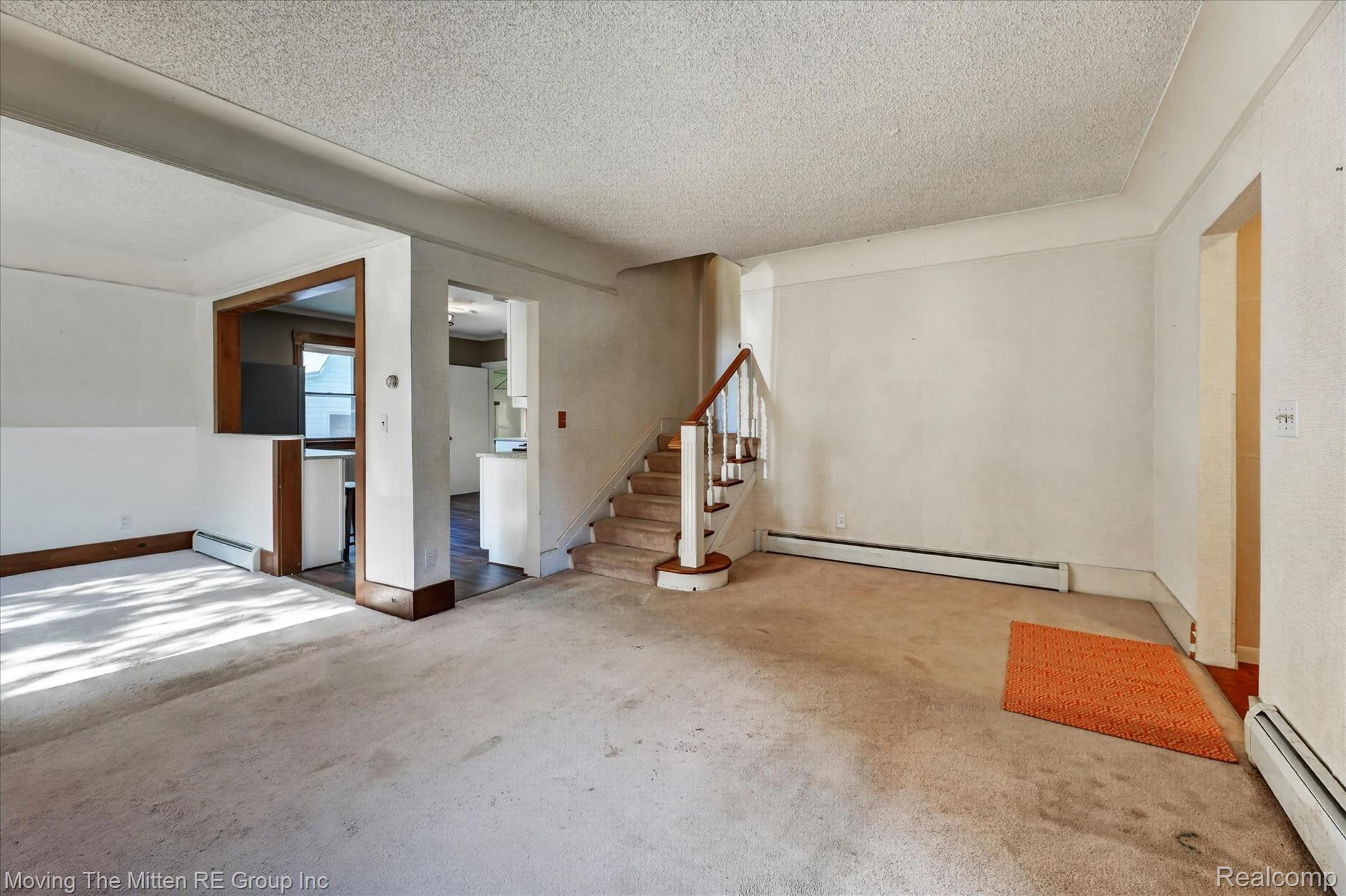 25505 Wick Road Taylor, MI 48180 - Photo 15 of 68 Unfurnished room with a textured ceiling, a baseboard radiator, and carpet
