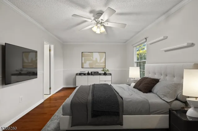 a bedroom with a large bed and a flat screen tv