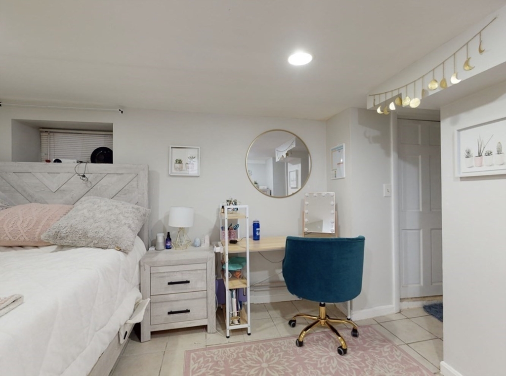 32 South Huntington Avenue, Unit 1 Boston, MA 02130 - Photo 11 of 17 a bedroom with a bed a dresser and chair