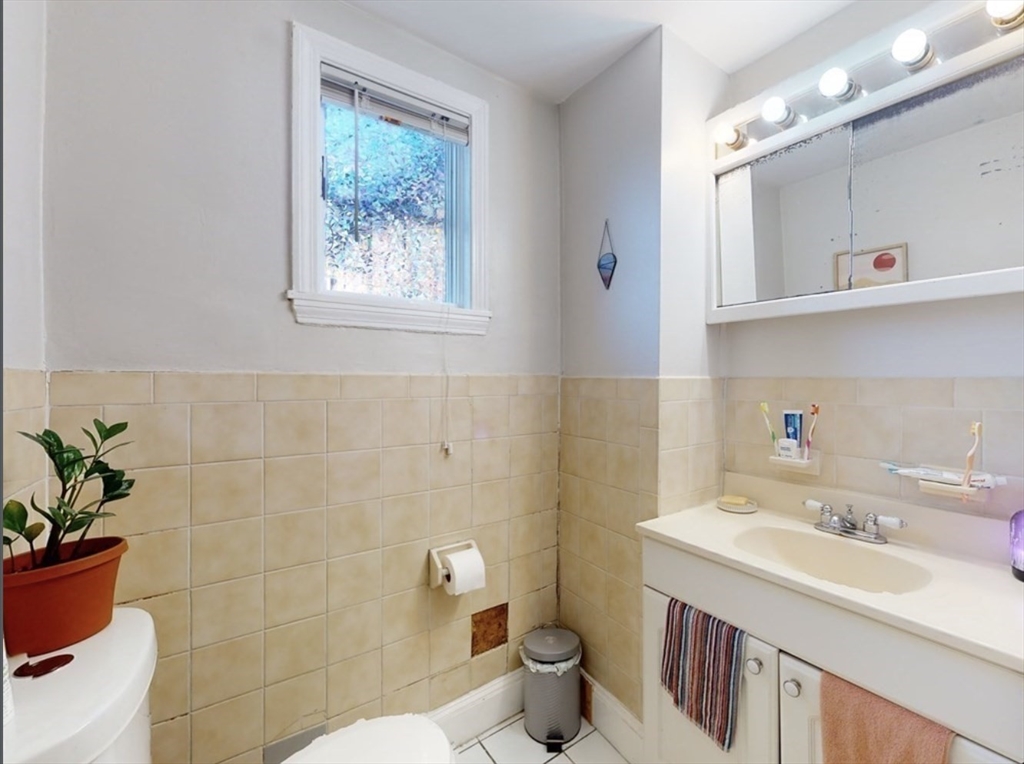 32 South Huntington Avenue, Unit 1 Boston, MA 02130 - Photo 16 of 17 a bathroom with a sink mirror and toilet