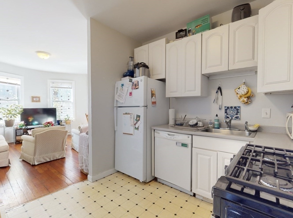 32 South Huntington Avenue, Unit 1 Boston, MA 02130 - Photo 4 of 17 a kitchen with stainless steel appliances a stove a sink and a refrigerator