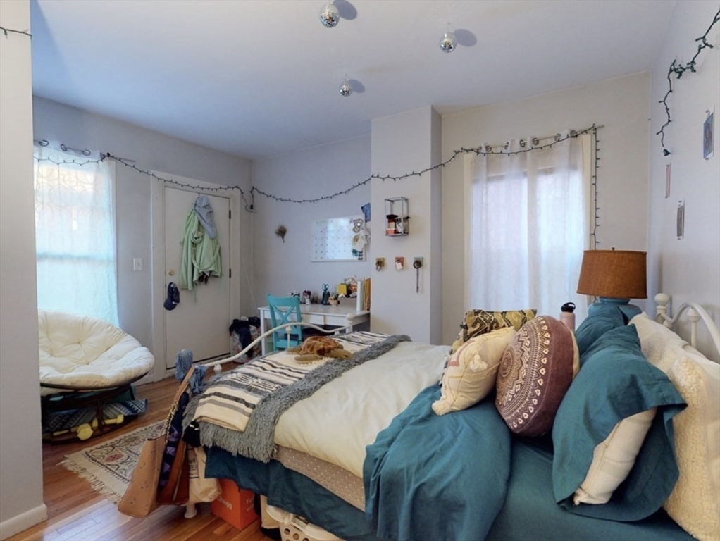 32 South Huntington Avenue, Unit 1 Boston, MA 02130 - Photo 6 of 17 a bedroom with a bed and wooden floor