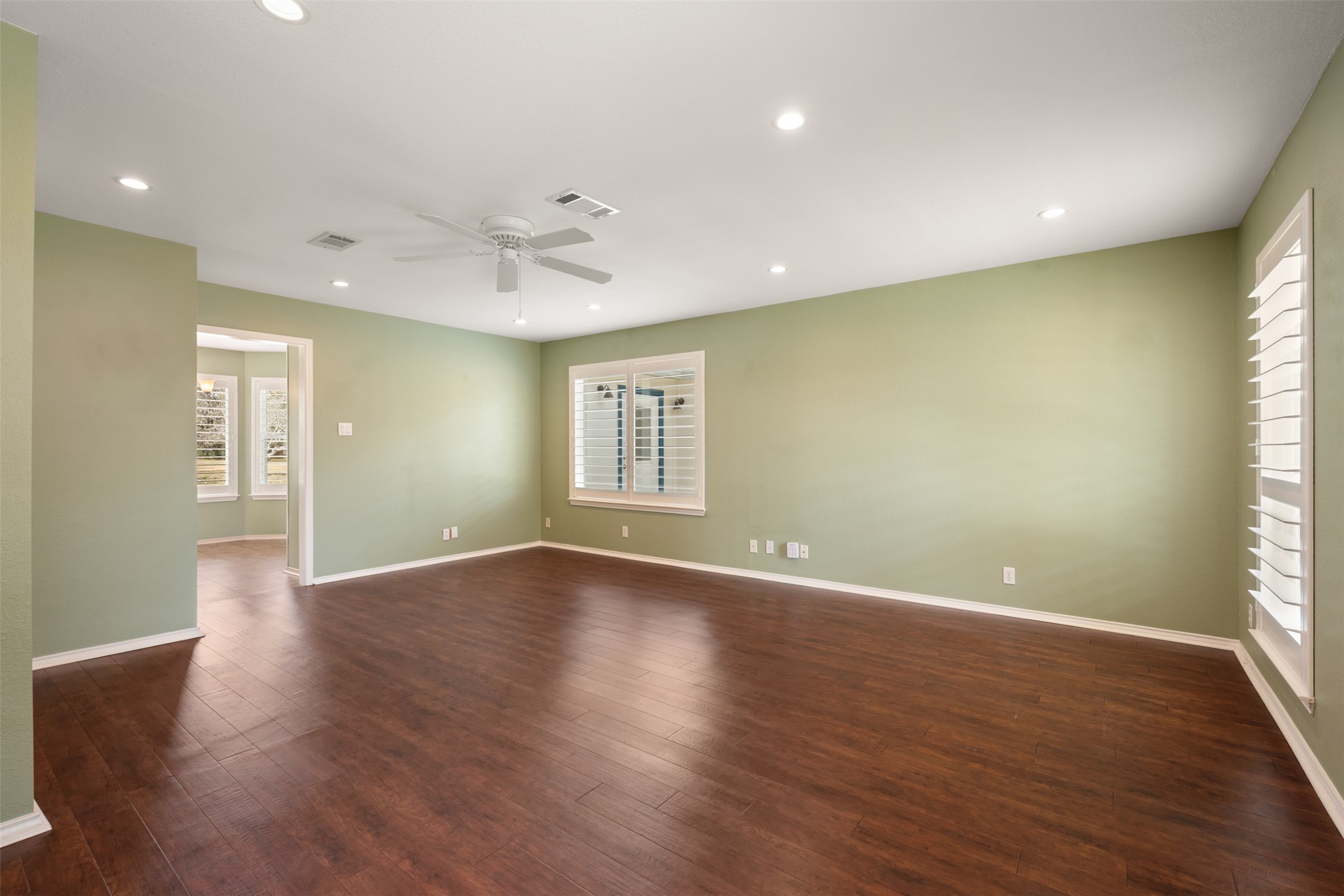 104 Sunset Road Georgetown, TX 78633 - Photo 18 of 40 Unfurnished room with plenty of natural light, dark wood-style flooring, a ceiling fan, and recessed lighting