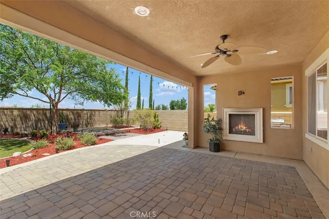 a view of a porch with furniture and a yard