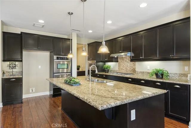 a kitchen with kitchen island a counter space a sink and cabinets