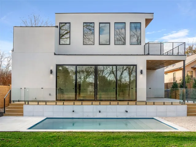 a view of swimming pool with outdoor seating and yard