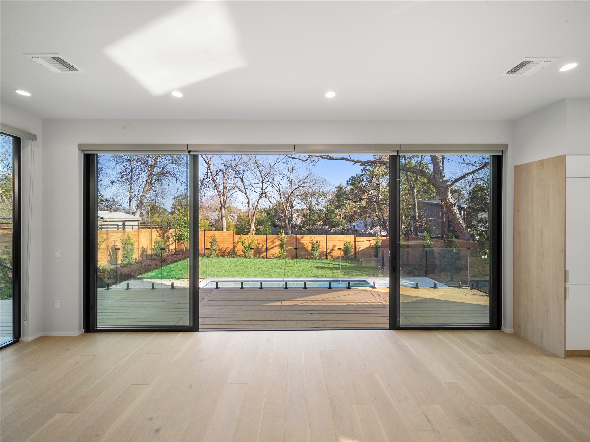 2107 Brackenridge Street, Unit B Austin, TX 78704 - Photo 11 of 36 an empty room with large windows and a large window