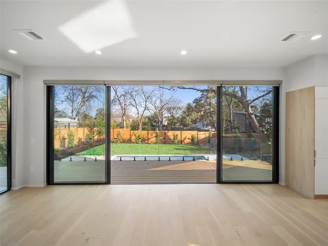 an empty room with large windows and a large window