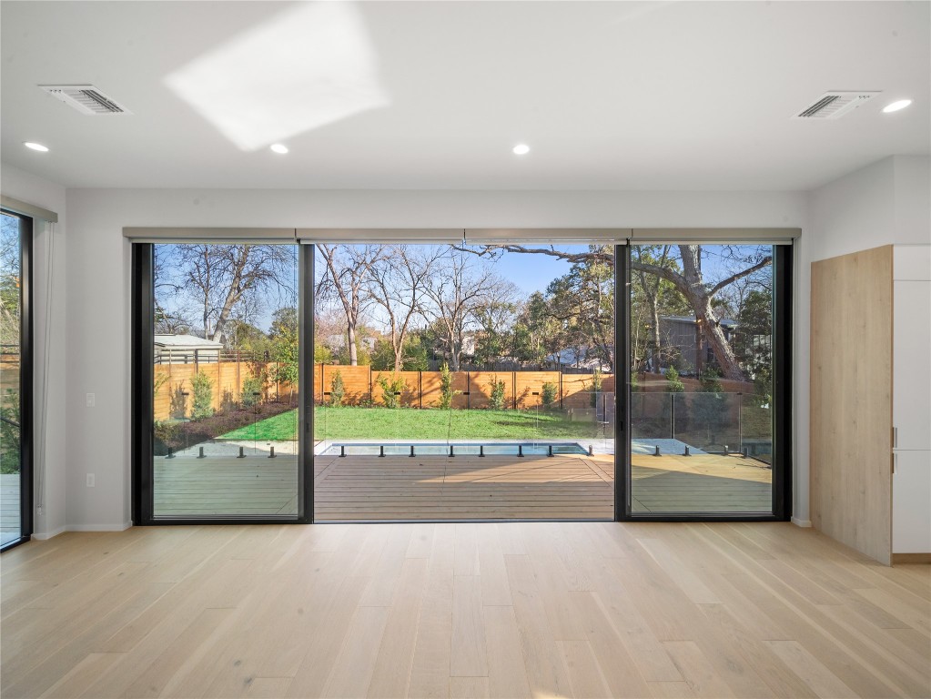 2107 Brackenridge Street, Unit B Austin, TX 78704 - Photo 11 of 36 an empty room with large windows and a large window