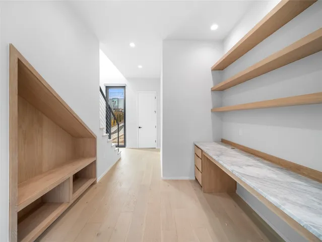 a view of hallway with stairs and wooden floor