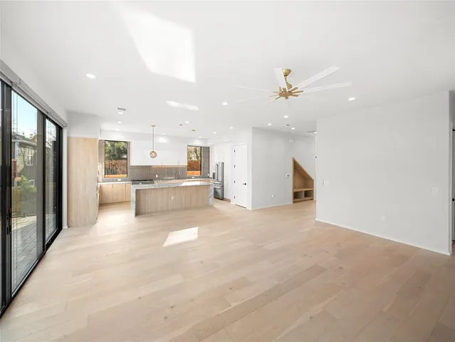 a view of a kitchen with a sink and a large window