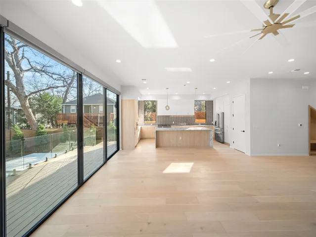 a large white kitchen with a large window