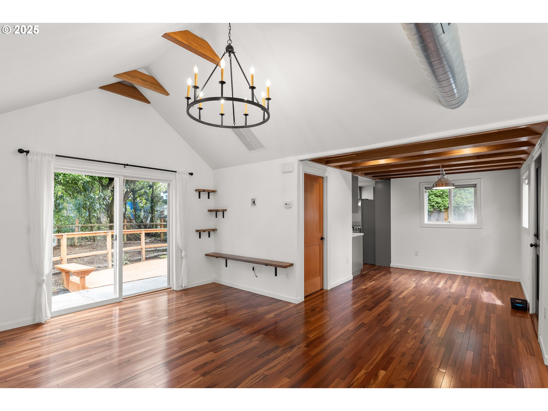 4824 Southwest Shattuck Road Portland, OR 97221 - Photo 5 of 28 a view of an empty room with wooden floor and windows