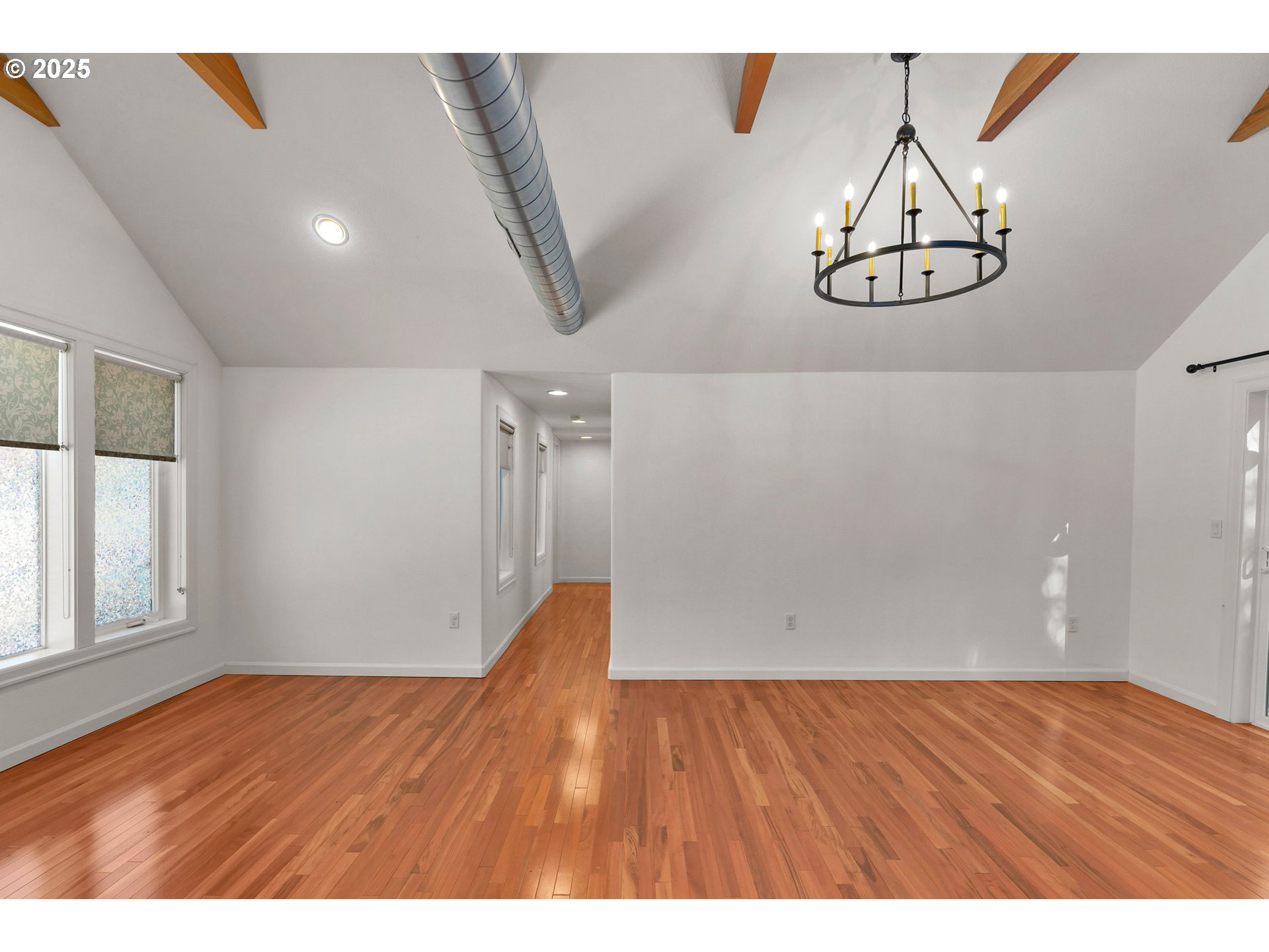 4824 Southwest Shattuck Road Portland, OR 97221 - Photo 8 of 28 a view of an empty room with wooden floor