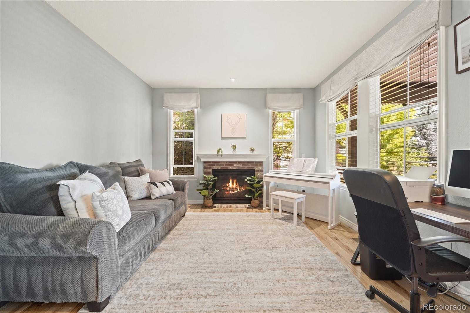 10466 Marigold Court Highlands Ranch, CO 80126 - Photo 13 of 50 a living room with furniture and a fireplace