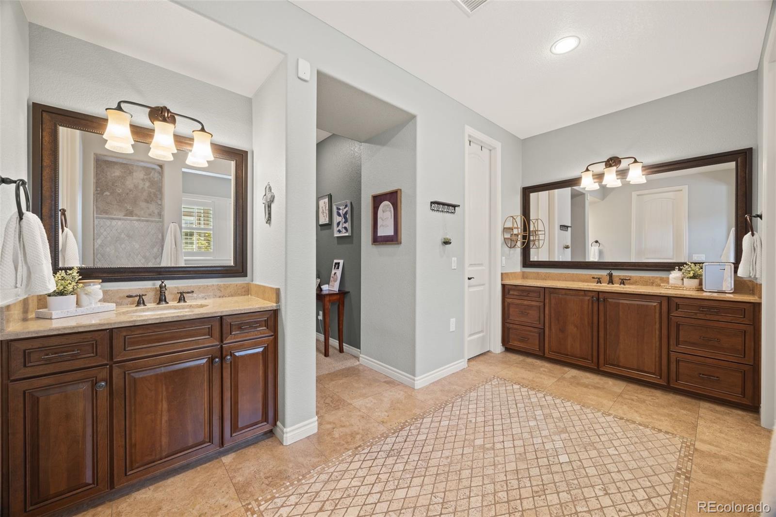 10466 Marigold Court Highlands Ranch, CO 80126 - Photo 20 of 50 a large bathroom with a large tub sink and mirror