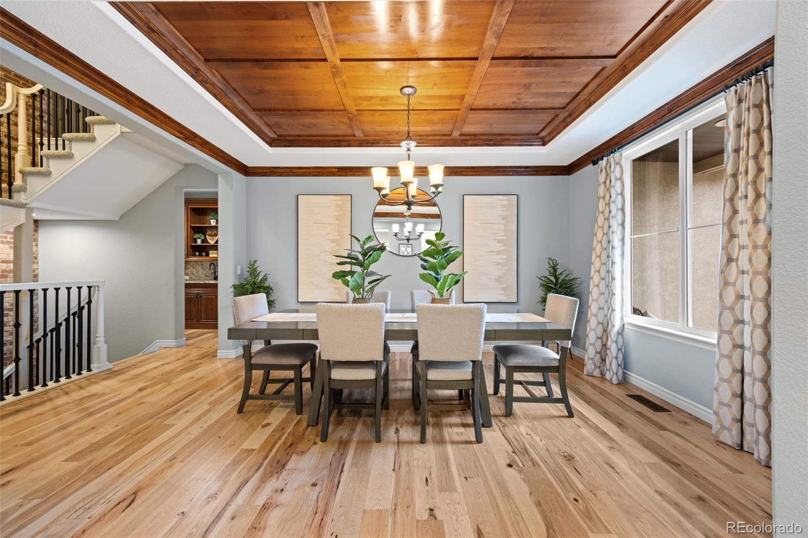 10466 Marigold Court Highlands Ranch, CO 80126 - Photo 3 of 50 a view of a dining room with furniture window and wooden floor