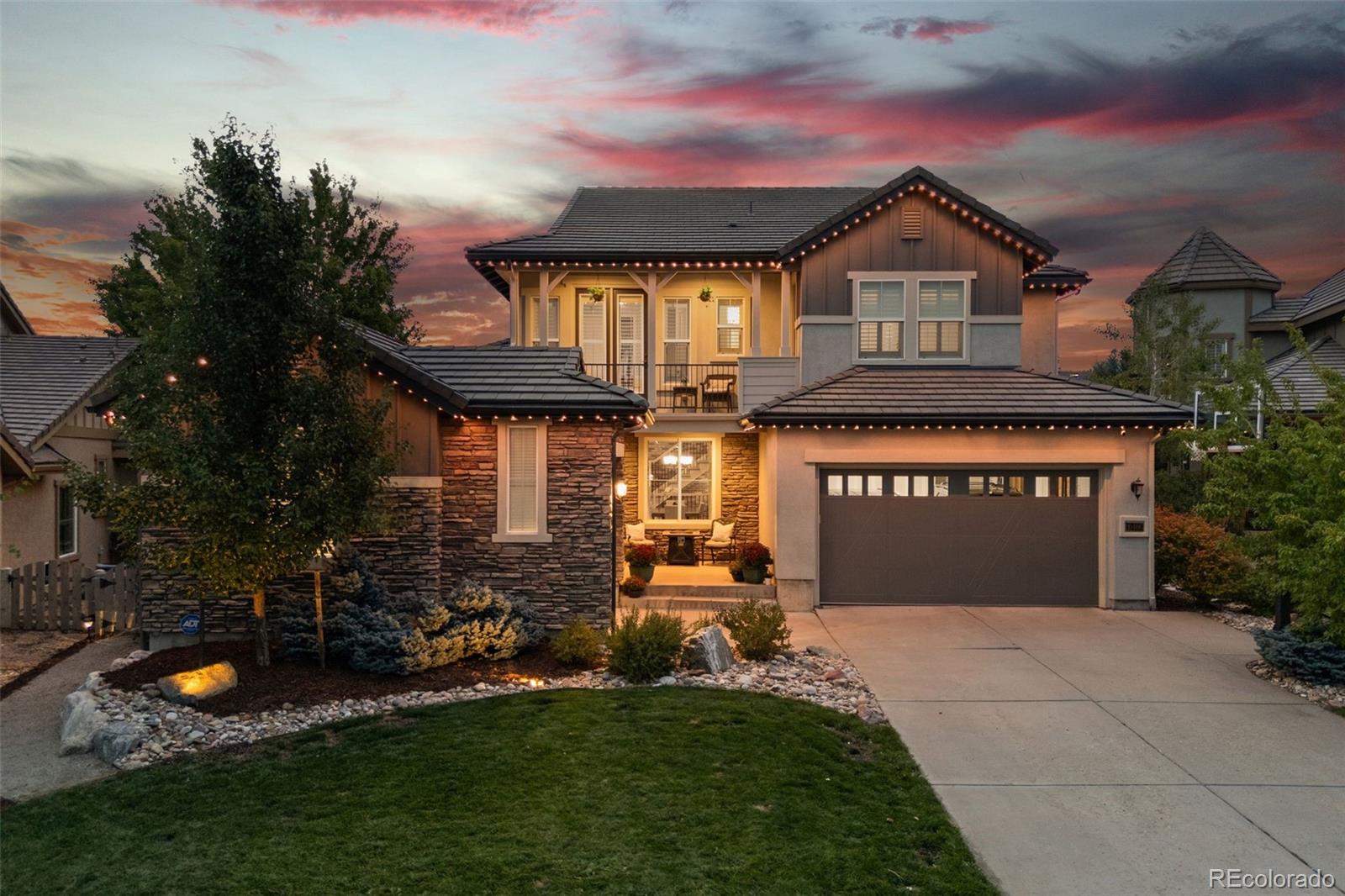 10466 Marigold Court Highlands Ranch, CO 80126 - Photo 36 of 50 a front view of a house with a yard