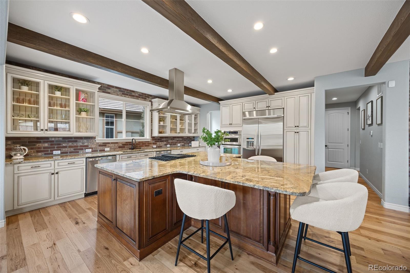 10466 Marigold Court Highlands Ranch, CO 80126 - Photo 7 of 50 a kitchen with granite countertop kitchen island stainless steel appliances a sink and counter space