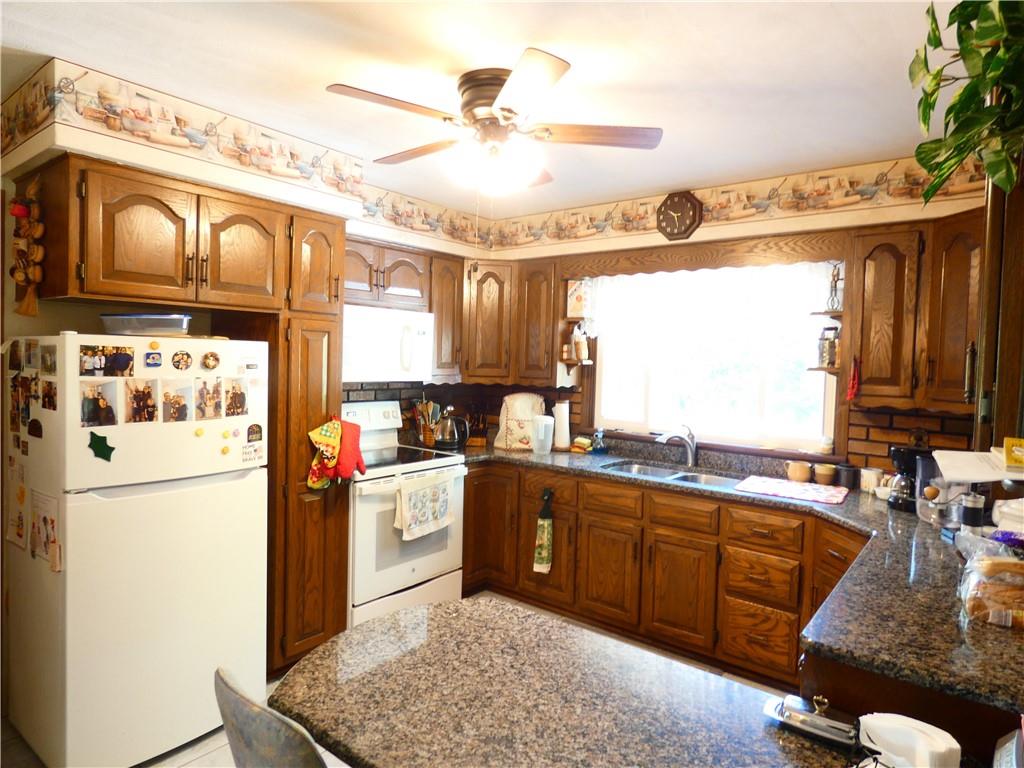 2223 Sandy Lake-Grove City Road Jackson Center, PA 16133 - Photo 14 of 30 a kitchen with a sink appliances and cabinets