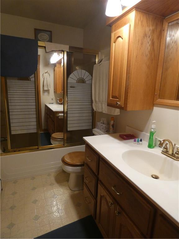 2223 Sandy Lake-Grove City Road Jackson Center, PA 16133 - Photo 16 of 30 a bathroom with a sink a toilet and mirror