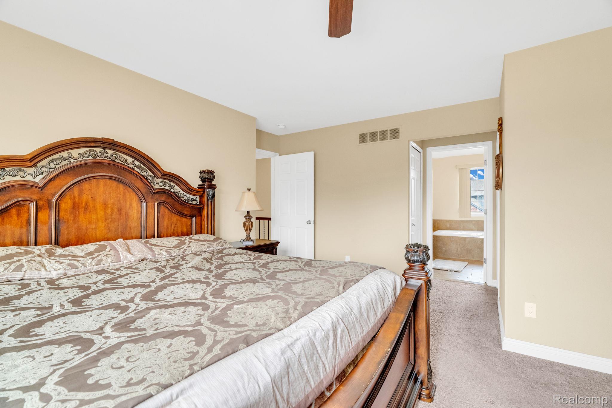 4122 Hawks Nest Road Utica, MI 48317 - Photo 39 of 74 Bedroom featuring light colored carpet, ensuite bathroom, and ceiling fan