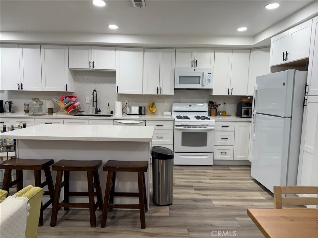 682 East Workman Street Covina, CA 91723 - Photo 8 of 36 a kitchen with refrigerator cabinets and wooden floor