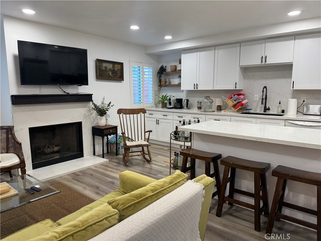 682 East Workman Street Covina, CA 91723 - Photo 8 of 34 a living room with furniture a flat screen tv and a fireplace