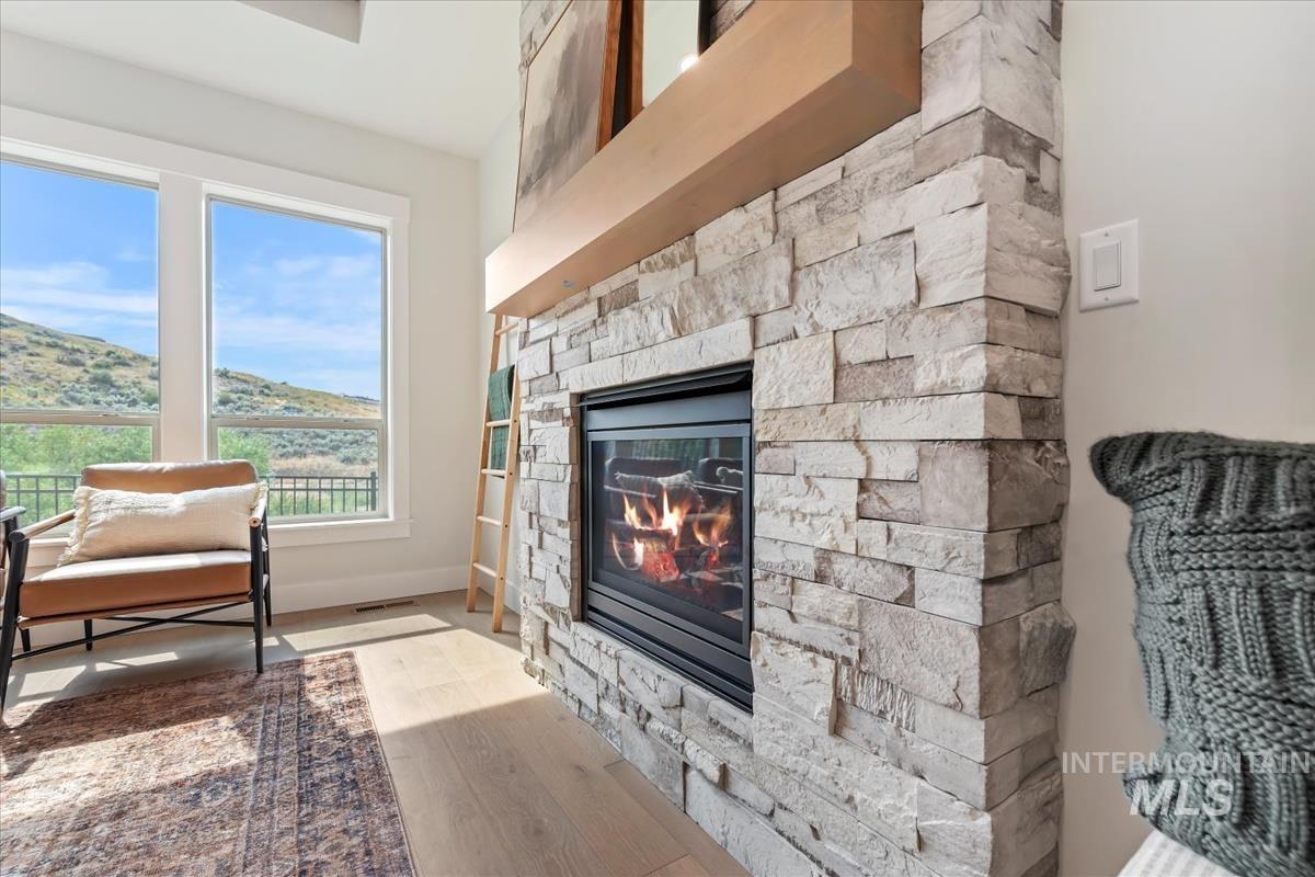2166 East Rodeo Street Kuna, ID 83634 - Photo 7 of 43 Stone-faced fireplace with a substantial wood mantel