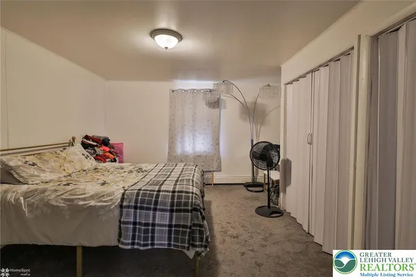 a bedroom with a bed and a chair