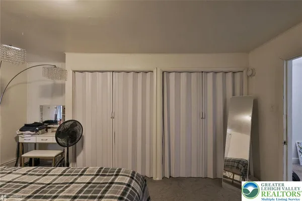 a bedroom with a bed and a mirror