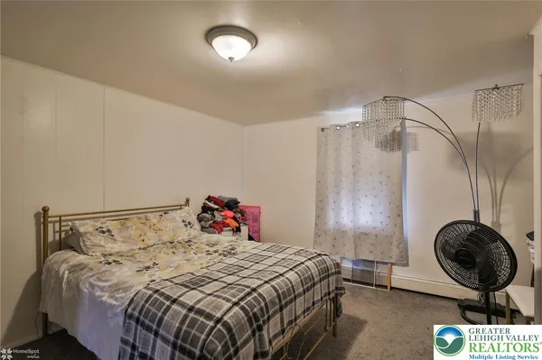 a bedroom with furniture and a book shelf
