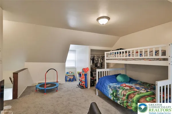 a bedroom with furniture and a window