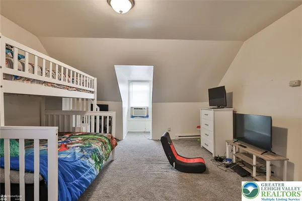 a bedroom with furniture and a baby crib