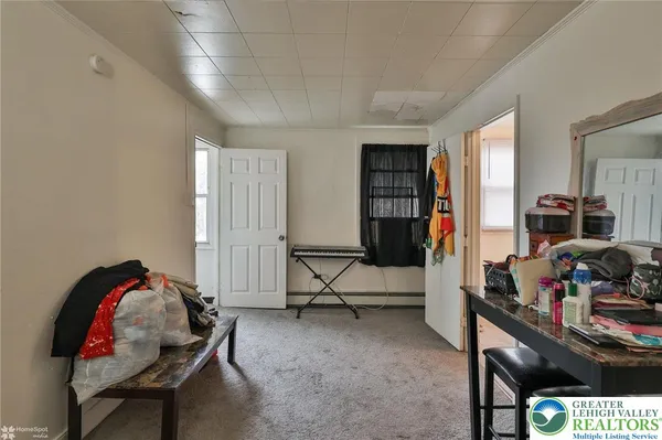 a living room with furniture a flat screen tv and a window