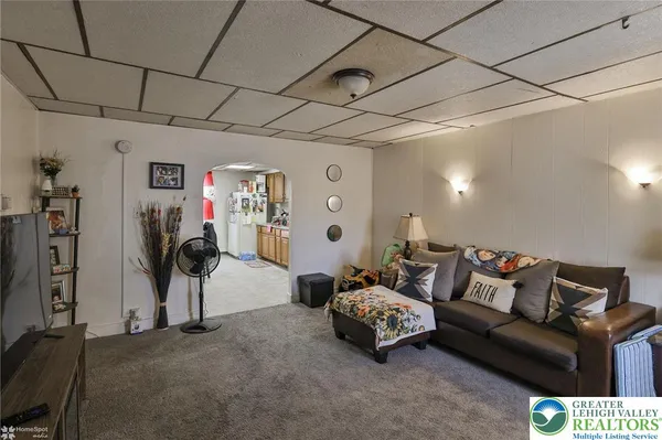 a living room with furniture and a gym machine