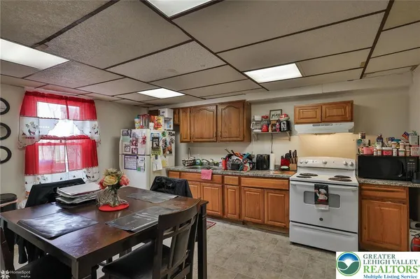 a kitchen with a stove a refrigerator and a dining table