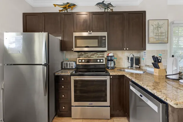 a kitchen with a stove and a refrigerator