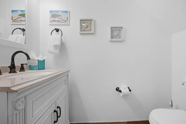 a bathroom with a sink vanity and toilet
